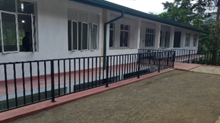White school building with fence